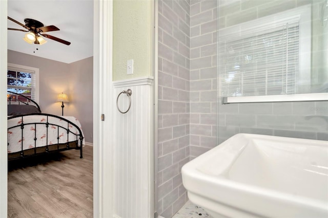 bathroom featuring ceiling fan and hardwood / wood-style flooring