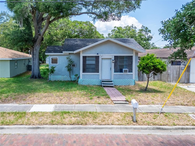 bungalow-style home featuring a front lawn