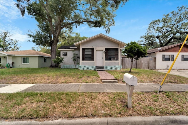 bungalow-style house featuring a front lawn