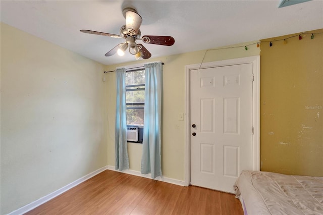 unfurnished bedroom with ceiling fan, a closet, and wood-type flooring