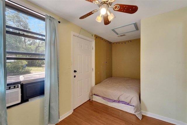 bedroom with hardwood / wood-style floors and ceiling fan