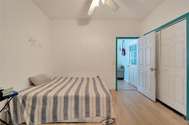 bedroom with ceiling fan, a closet, and light hardwood / wood-style floors