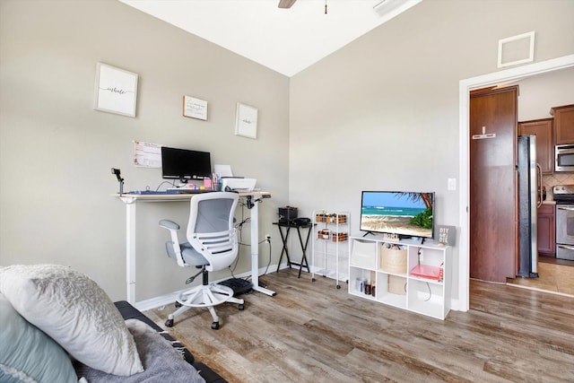 office area with ceiling fan and light hardwood / wood-style flooring