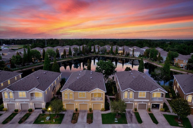 aerial view at dusk with a water view