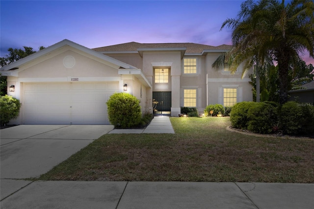 view of front of home with a lawn and a garage