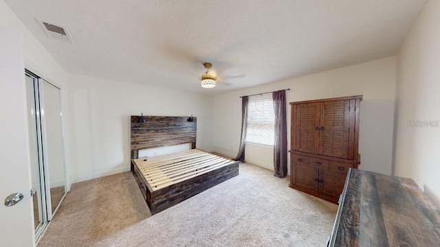 carpeted bedroom with a closet and ceiling fan