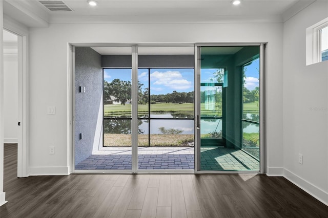 doorway to outside with crown molding, dark hardwood / wood-style flooring, and a water view