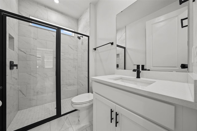 bathroom featuring vanity, an enclosed shower, and toilet