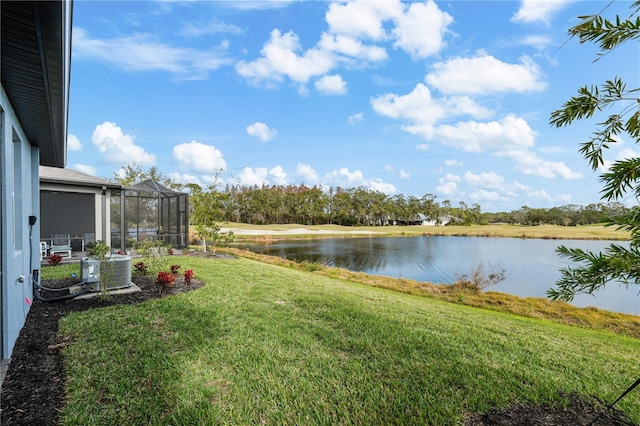 view of yard with central AC unit, glass enclosure, and a water view