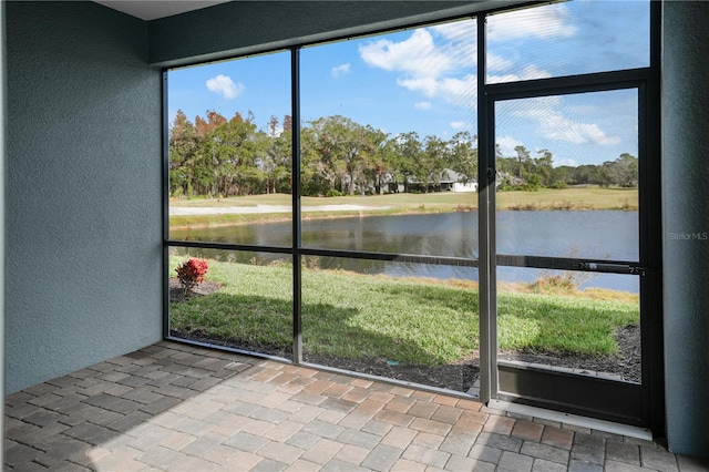 unfurnished sunroom with a water view