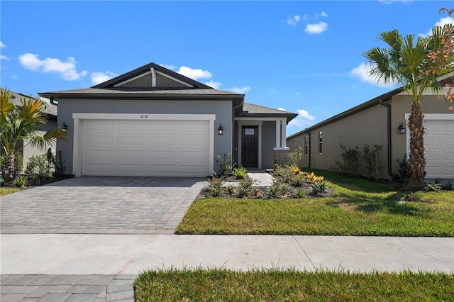 ranch-style home with a front lawn and a garage