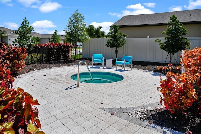 view of pool with a patio area and an in ground hot tub