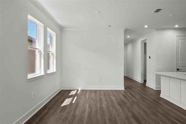 empty room with dark hardwood / wood-style floors and ornamental molding