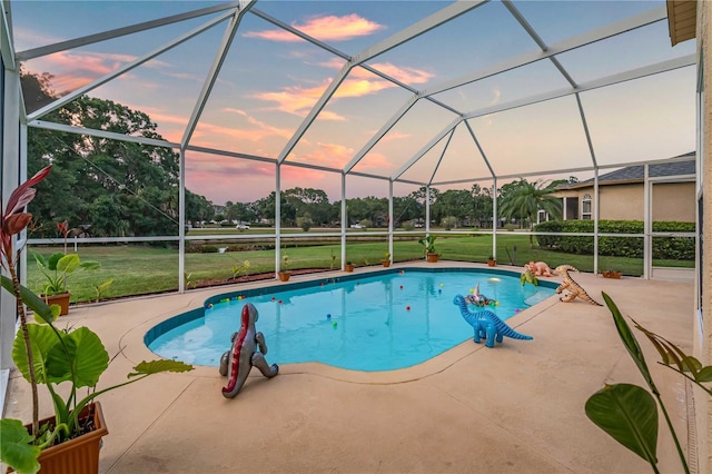 pool at dusk featuring a lanai, a lawn, an outdoor pool, and a patio
