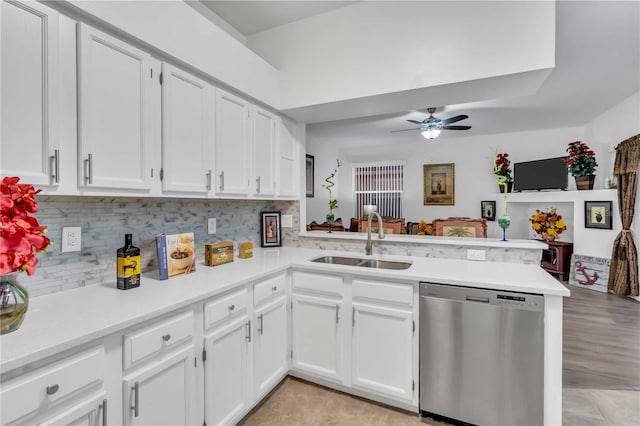 kitchen with ceiling fan, kitchen peninsula, dishwasher, sink, and white cabinetry