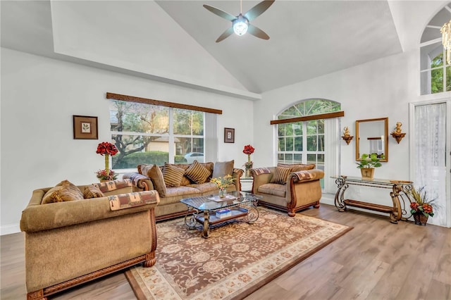 living room featuring high vaulted ceiling, ceiling fan, and wood finished floors