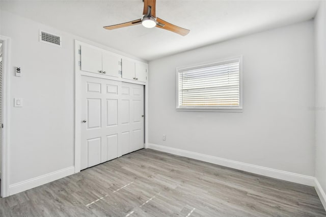 unfurnished bedroom with ceiling fan, a closet, and light hardwood / wood-style floors