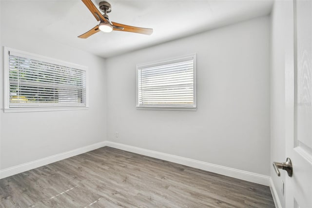 spare room with ceiling fan and hardwood / wood-style flooring