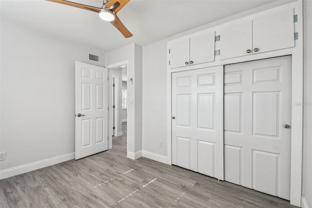 unfurnished bedroom with ceiling fan, light hardwood / wood-style floors, and a closet