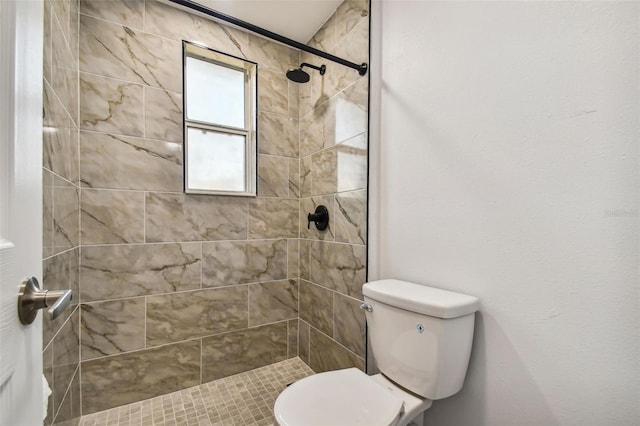 bathroom featuring toilet and tiled shower