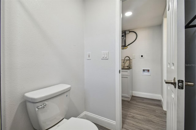 bathroom featuring hardwood / wood-style floors, toilet, and sink