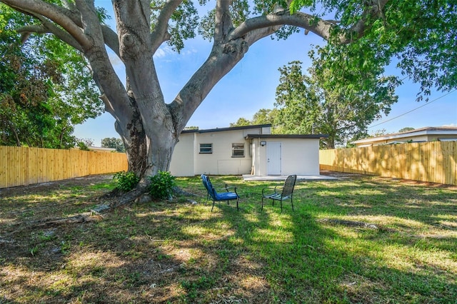 rear view of property featuring a yard