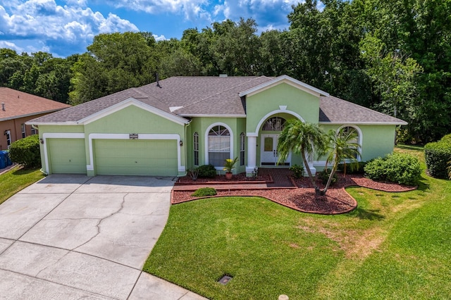 single story home featuring a garage and a front lawn