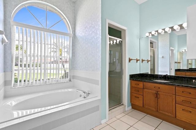 bathroom featuring tile floors, shower with separate bathtub, and large vanity