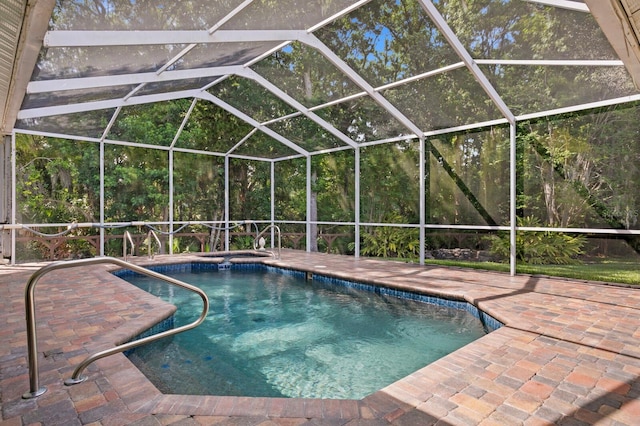 view of pool with a patio and glass enclosure