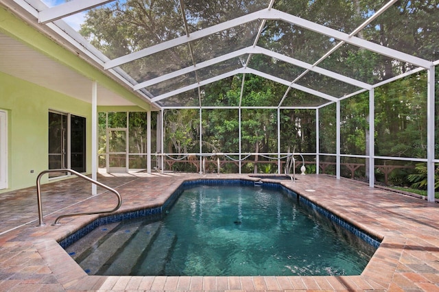 view of pool with a patio area and a lanai