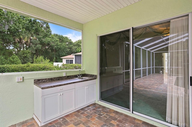 exterior space featuring sink and glass enclosure