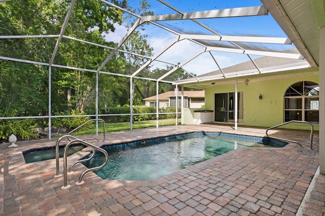 view of pool featuring ceiling fan, a lanai, and a patio area