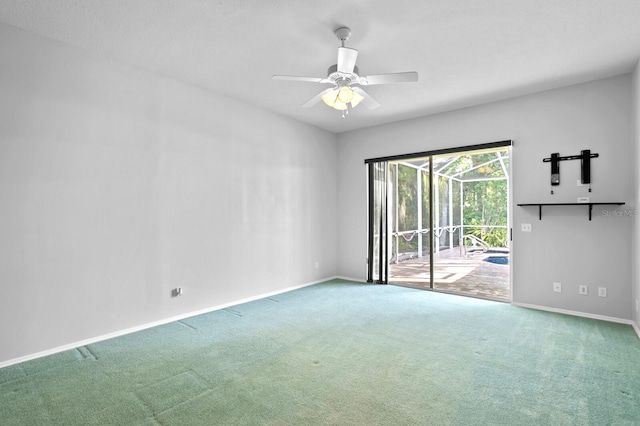 spare room featuring carpet and ceiling fan