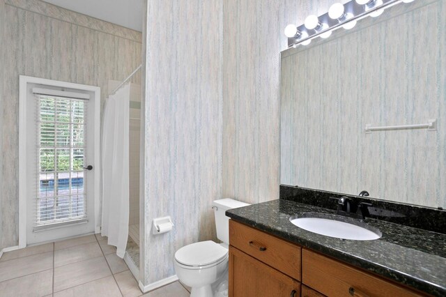 bathroom with tile flooring, vanity, and toilet