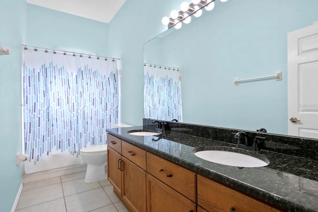 bathroom with double vanity, tile flooring, and toilet