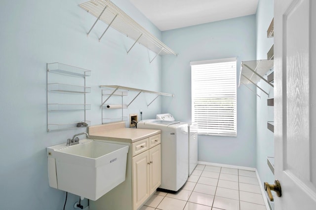 laundry area with cabinets, hookup for a washing machine, sink, washing machine and dryer, and light tile flooring