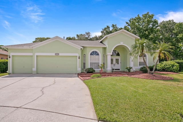 mediterranean / spanish home with a garage and a front yard