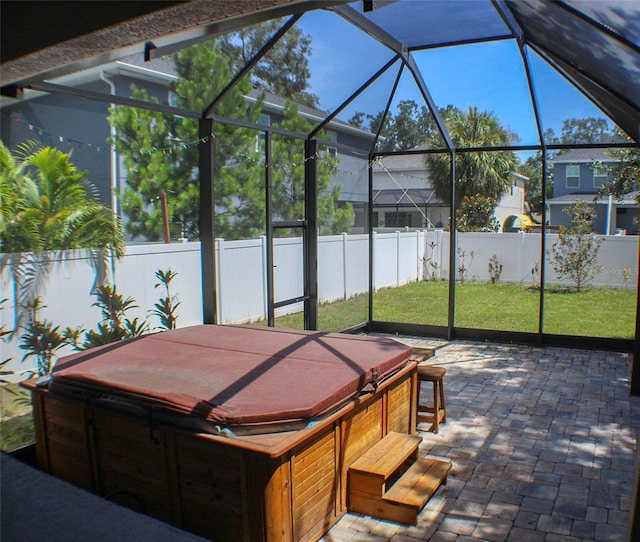 view of patio with a hot tub and a lanai