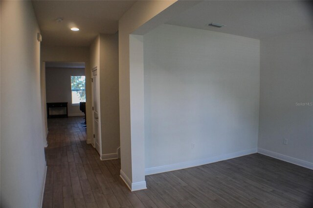 hallway with dark wood-type flooring