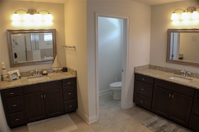 bathroom featuring vanity, tile patterned flooring, and toilet