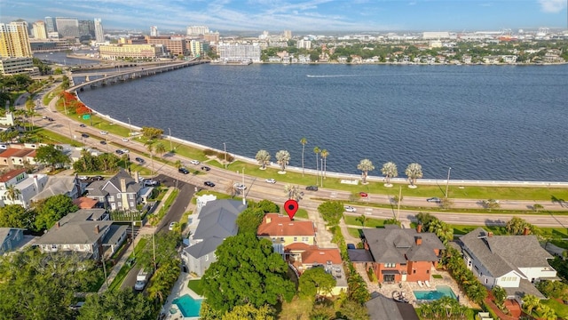 birds eye view of property with a view of city and a water view