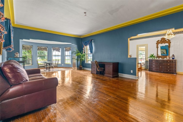 living room with plenty of natural light, ornamental molding, and hardwood / wood-style flooring