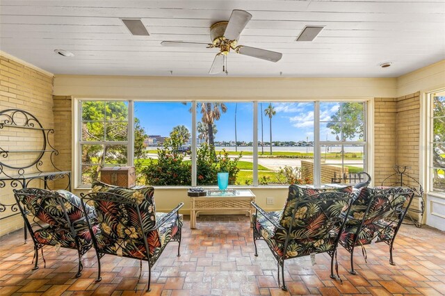 sunroom / solarium featuring ceiling fan