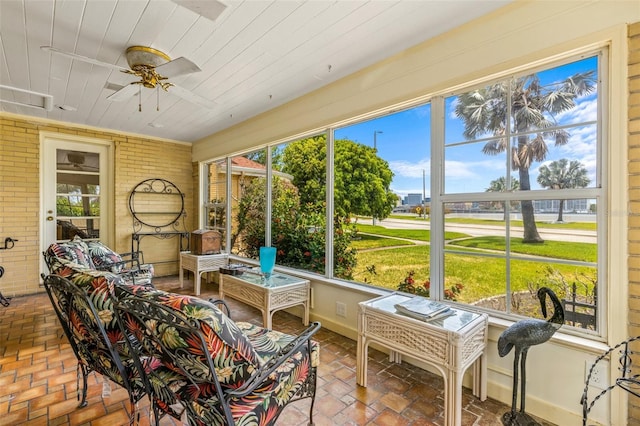 sunroom / solarium featuring wooden ceiling and ceiling fan