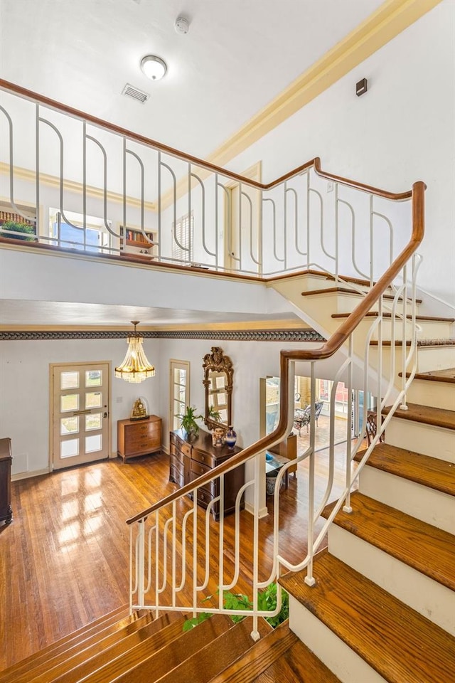 staircase with hardwood / wood-style flooring