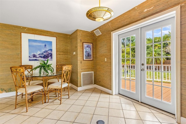 dining area featuring light tile patterned floors, french doors, visible vents, and baseboards