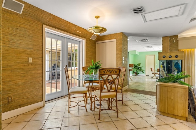 dining space with french doors, visible vents, and light tile patterned floors