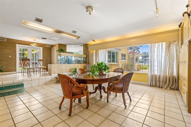 dining room featuring french doors, visible vents, and light tile patterned floors