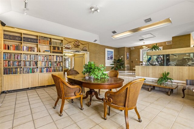 tiled dining area featuring rail lighting