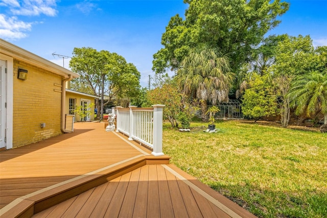 wooden deck featuring a lawn